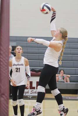 Lady Cardinal Sophie Hudson leaps up to return the ball to Three Way in the Oct. 1 home game. Paul Gaudette | Citizen staff photo