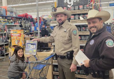 While being pushed around in a cart, Game Wardens aid a young lady in picking out a tablet. Wyndi Veigel-Gaudette | Citizen staff photo