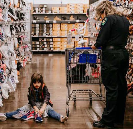 A child gets help picking out shoes from Dublin PD Detective Nanci Wilson at last year’s event. Courtesy photo