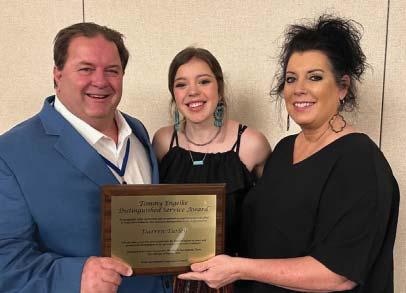 Darren, Madison and Deanna Turley pose with the 2022 Tommy Engelke Distinguished Service Award which Daren received at the annual Texas Agricultural Cooperative Council meeting.