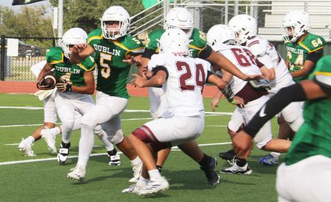 Dublin JV Lions battle Bowie Jackrabbits to move the ball up the field in a home game Thursday, Sept. 18 on Cervetto field while Jr. High Cheerleaders issue support from the sideline. The game ended in a win for the visiting team. Paul Gaudette | Citizen staff photos